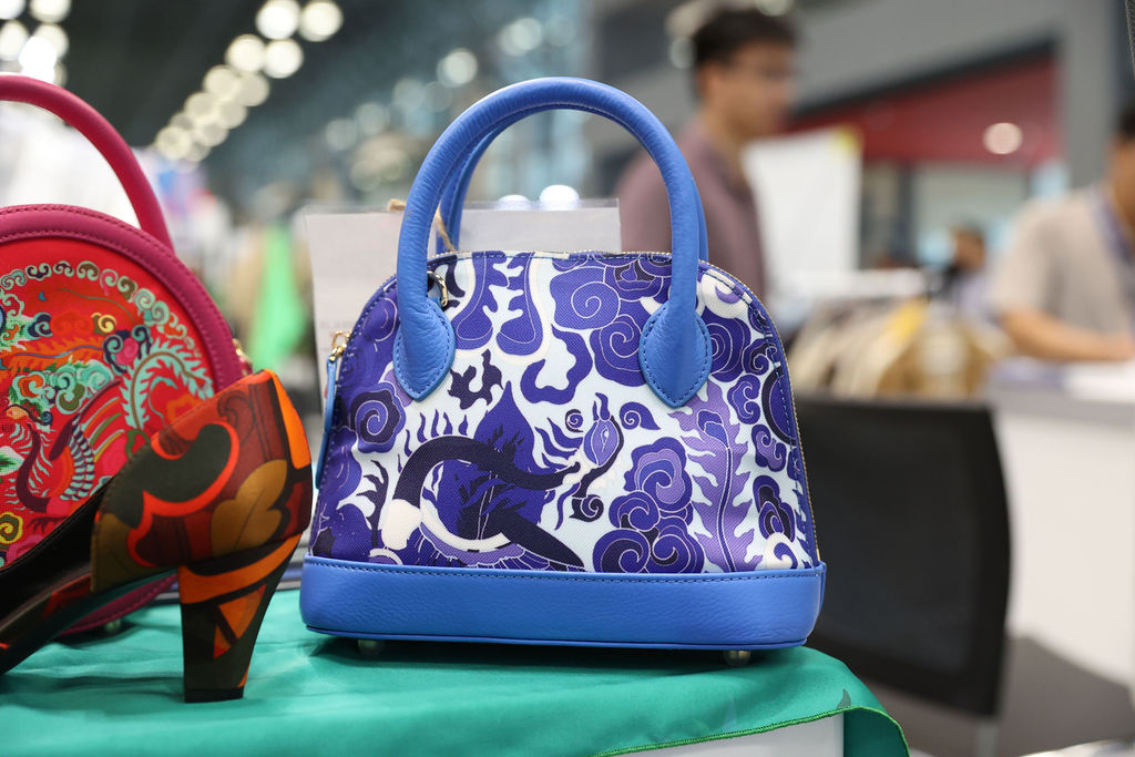 Handbag with intricate patterns showcased at a booth at Texworld New York.